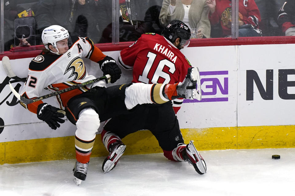 Anaheim Ducks defenseman Josh Manson, left, is checked by Chicago Blackhawks left wing Jujhar Khaira during the second period of an NHL hockey game in Chicago, Saturday, Jan. 15, 2022. (AP Photo/Nam Y. Huh)