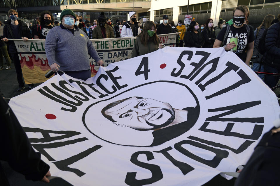 Demonstrators gather outside the Hennepin County Government Center, Monday, March 8, 2021, in Minneapolis where the trial for former Minneapolis police officer Derek Chauvin began with jury selection. Chauvin is charged with murder in the death of George Floyd during an arrest last May in Minneapolis. (AP Photo/Jim Mone)