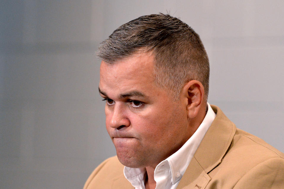 Brisbane coach Anthony Seibold looks dejected at a press conference.