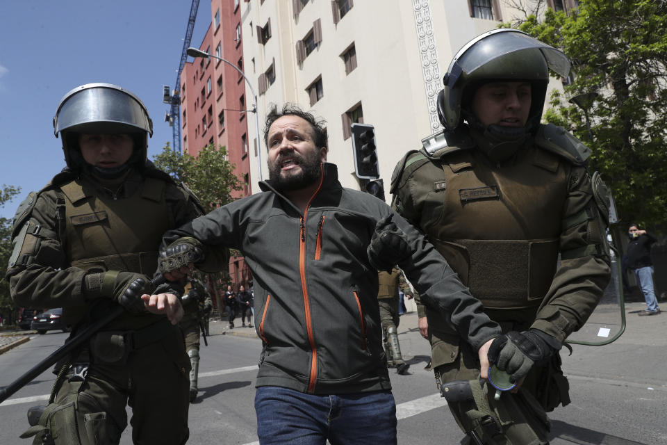 Police detain a demonstrator in Santiago, Chile, Sunday, Oct. 20, 2019. Protests in the country have spilled over into a new day, even after President Sebastian Pinera cancelled the subway fare hike that prompted massive and violent demonstrations. (Photo: Esteban Felix/AP)