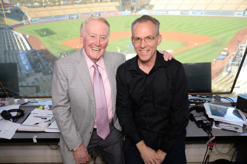 Legendary Dodgers broadcaster Vin Scully stands next to Dodgers historian Mark Langill at Dodger Stadium.