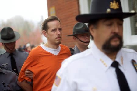 Eric Matthew Frein exits the Pike County Courthouse with police officers after an arraignment in Milford, Pennsylvania, in this file photo taken October 31, 2014. REUTERS/Mark Makela/Files