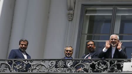 Iranian Foreign Minister Javad Zarif (R) listens questions from journalists as he stands next to Iran's chief nuclear negotiator Abbas Araghchi (L) and Hossein Fereydoon (2ndL), brother and close aide to President Hassan Rouhani, on the balcony of Palais Coburg, the venue for nuclear talks in Vienna, Austria, July 10, 2015. REUTERS/Leonhard Foeger