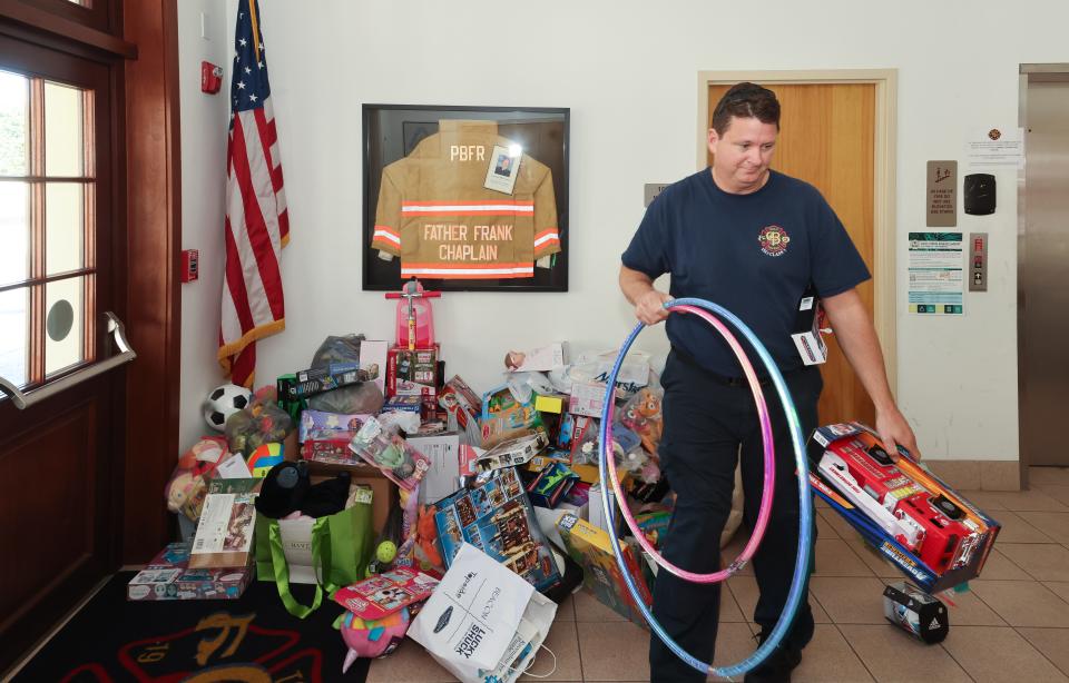 Palm Beach firefighter Damon Patrick helps to carry toys out of Fire-Rescue Station #1 that were collected for the 28th annual Town of Palm Beach United Way Toy Drive in December. The United Way's annual meeting is slated to be held April 19 at The Breakers.