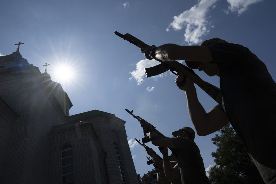 Ukrainian servicemen shoot into the air during a farewell ceremony for their fallen comrade Nicholas Maimer, a U.S. citizen and Army veteran who was killed during fighting in Bakhmut against Russian forces, in Ukrajinka, Ukraine, Wednesday, July 19, 2023. (AP Photo/Evgeniy Maloletka)