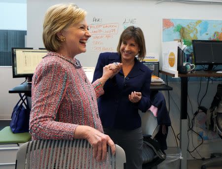 U.S. Democratic presidential candidate Hillary Clinton laughs with PanXchange CEO Julie Lerner at a campaign stop in Denver, U.S. June 28, 2016. REUTERS/Rick Wilking