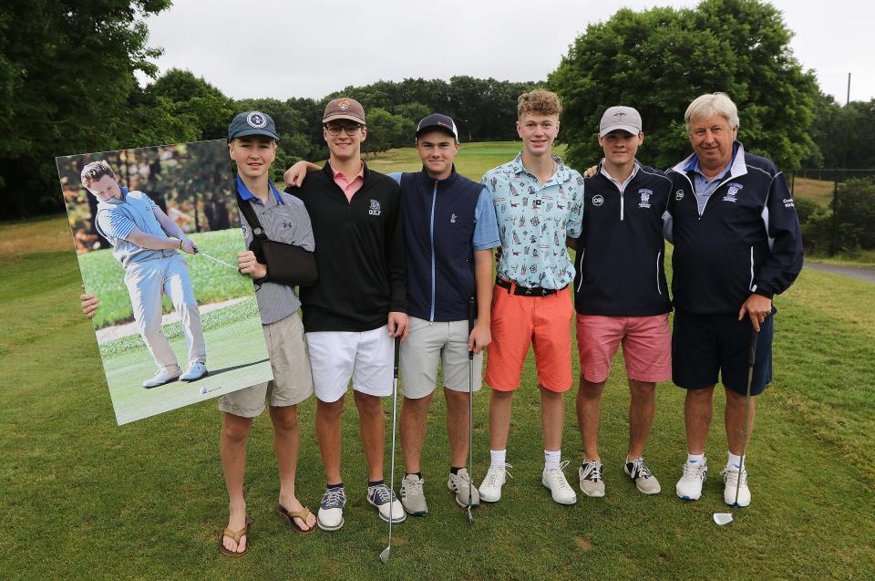 Before the start of the Owen Bingham Memorial Golf Tournament, Owen's teammates and coach from last fall's Dover-Sherborn Division 3 State Champion golf team pose for a group shot, June 22, 2022. Holding Owen's photo is Sean Scannell. Then, from the left, are Ben Schroeder, Tim Hill, Jack Potter, Curtis Bowman and coach Jon Kirby.