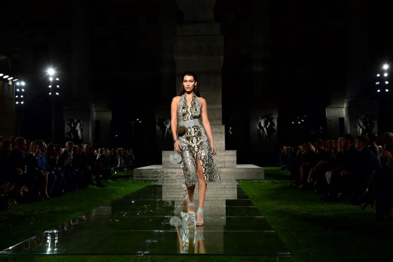 Salvatore Ferragamo's outdoor show, set in a field of sod laid for the occasion, saw models walking the looks on a glass catwalk among bloggers, buyers and fans of the 90-year-old house which won reknown for its shoes