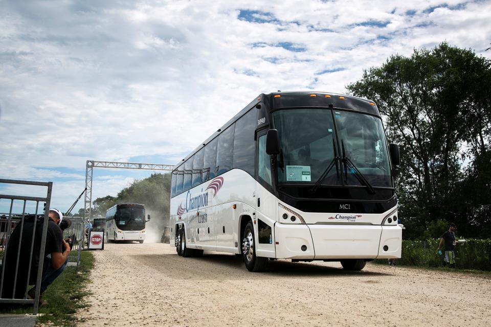 Team buses arrive before a Major League Baseball game between the Cincinnati Reds and Chicago Cubs on Thursday at the Field of Dreams in Dyersville, Iowa.