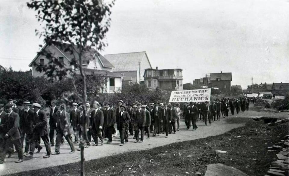 Sulphite workers from the Grand Falls paper mill march down High Street in a Labour Day parade ca. 1915.