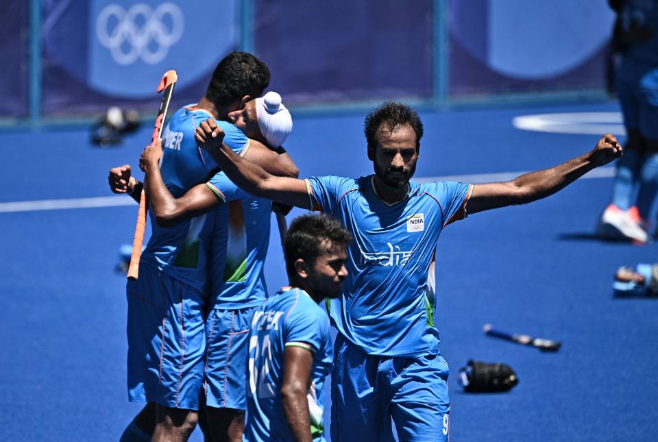 Players of India celebrate after winning the men's bronze medal match