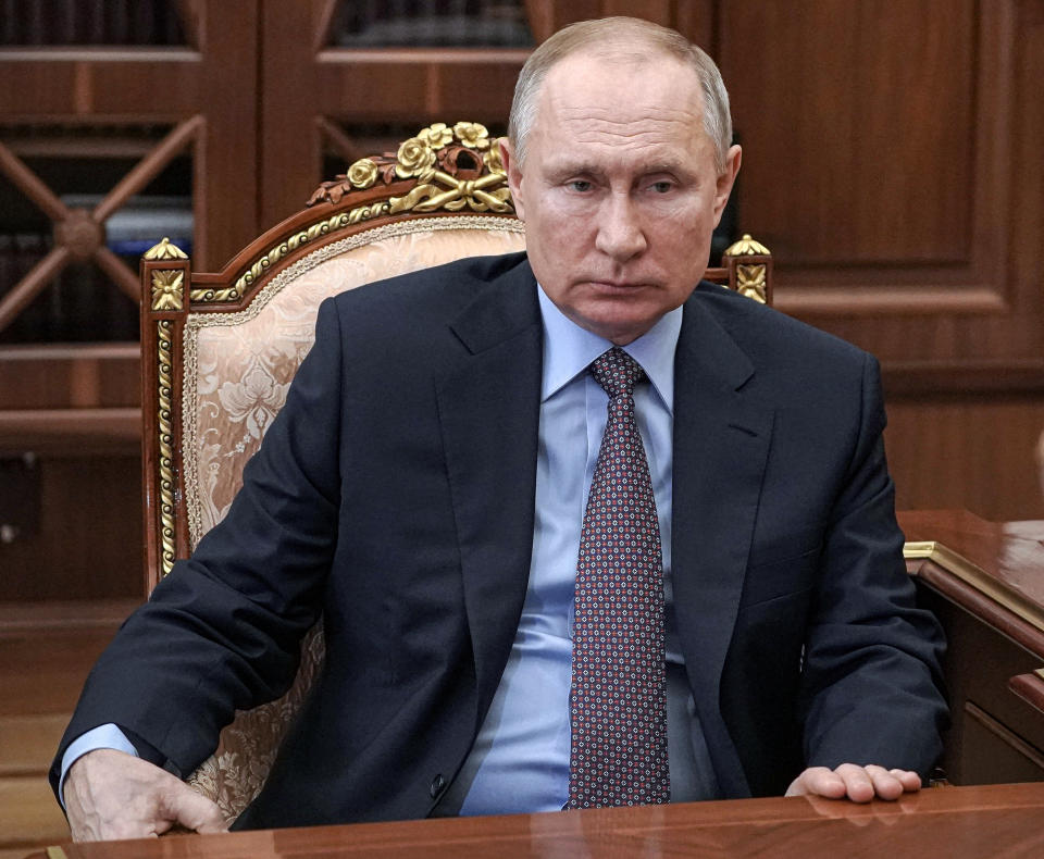 Russian President Vladimir Putin listens to Alexei Kudrin, the head of the chair of the Audit Chamber, back to a camera, during their meeting inn the Kremlin in Moscow, Russia, Tuesday, March 23, 2021. (Mikhail Klimentyev, Sputnik, Kremlin Pool Photo via AP)