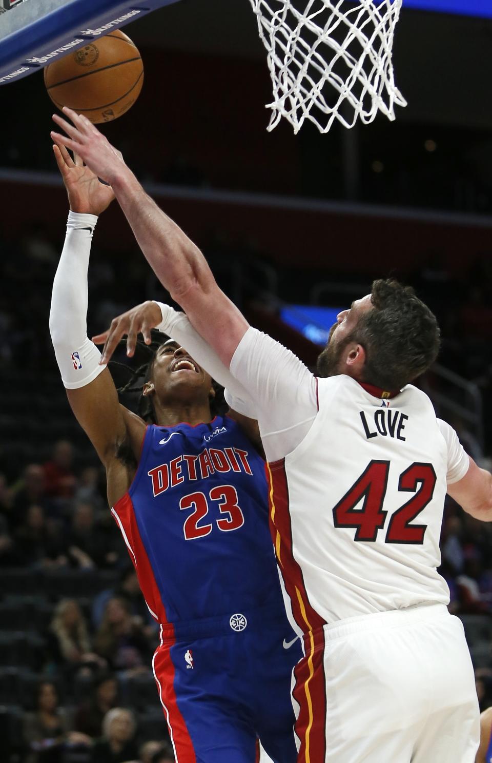 Detroit Pistons guard Jaden Ivey (23) takes a shot against Miami Heat forward Kevin Love (42) during the first half of an NBA basketball game, Sunday, March 19, 2023, in Detroit. (AP Photo/Duane Burleson)