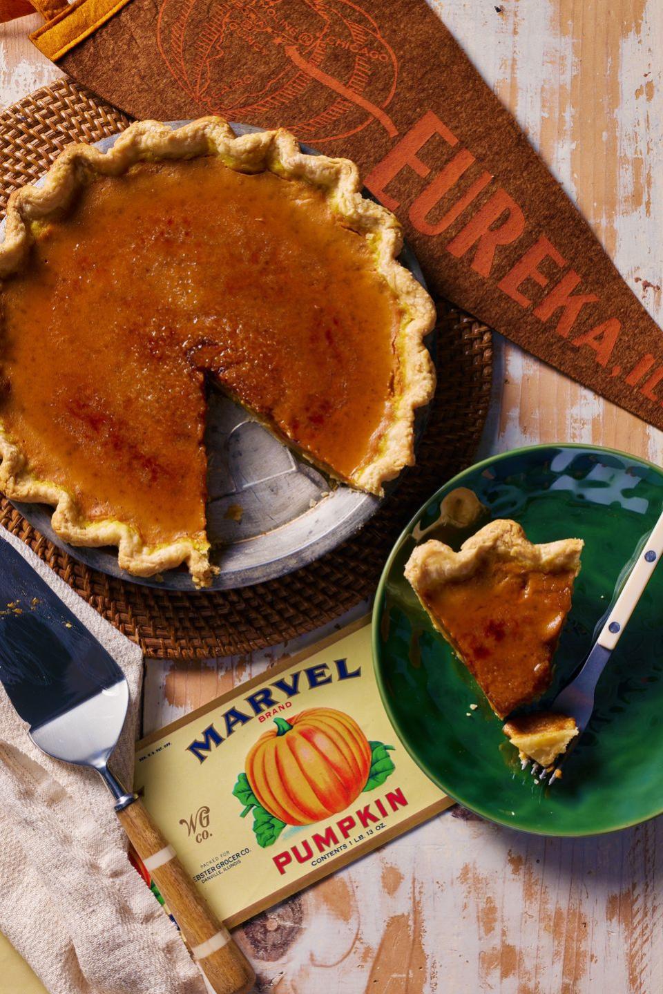 easy pumpkin pie in a metal pie plate with bruleed sugar on top and a slice removed and on a green plate with a fork