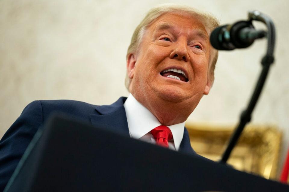 Donald Trump speaks during a ceremony to present the Presidential Medal of Freedom to former football coach Lou Holtz, in the Oval Office of the White House, Thursday, Dec. 3, 2020, in Washington, D.C.