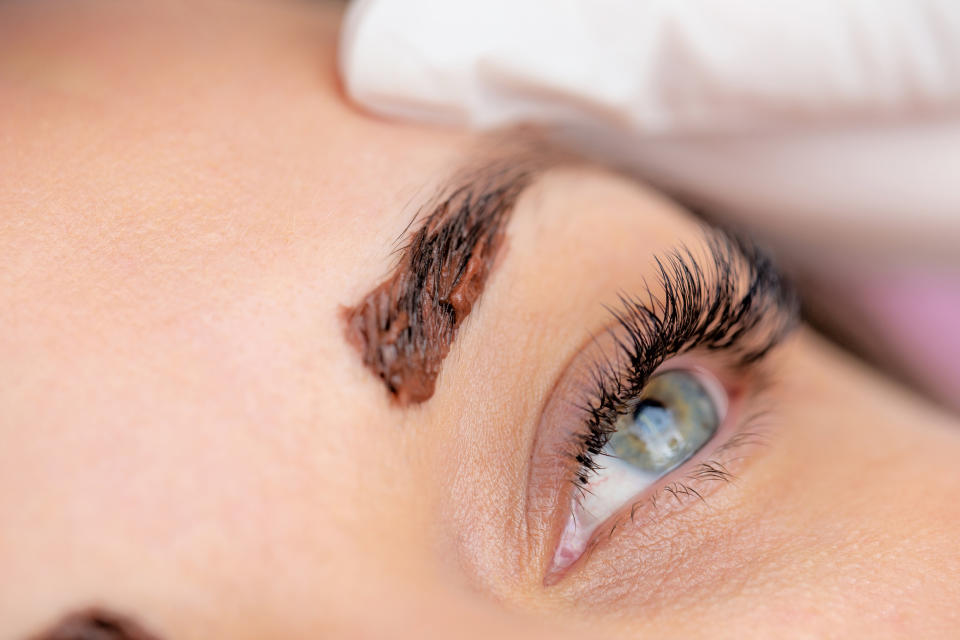 woman dyeing eyebrows