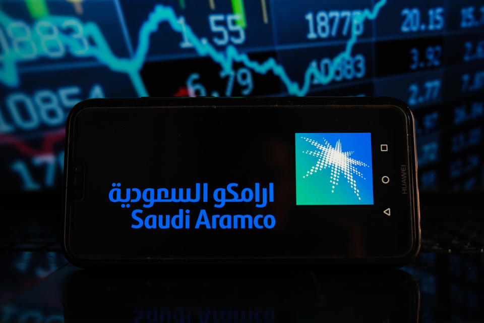 In this photo illustration a Saudi Aramco logo seen displayed on a smartphone with stock market percentages in the background. (Photo by Omar Marques / SOPA Images/Sipa USA)