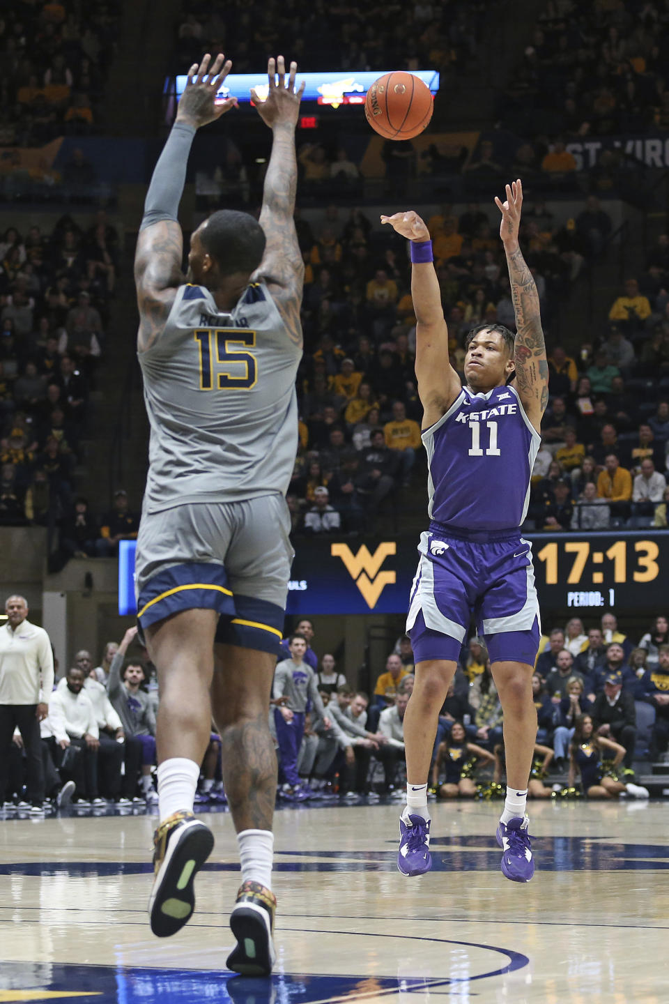 Kansas State forward Keyontae Johnson (11) shoots over West Virginia forward Jimmy Bell Jr. (15) during the first half of an NCAA college basketball game on Saturday, March 4, 2023, in Morgantown, W.Va. (AP Photo/Kathleen Batten)