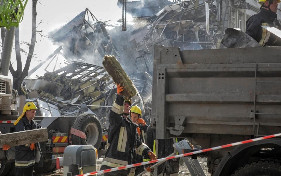 Rescuers work at a site of a building heavily damaged by a Russian missile attack in Odesa