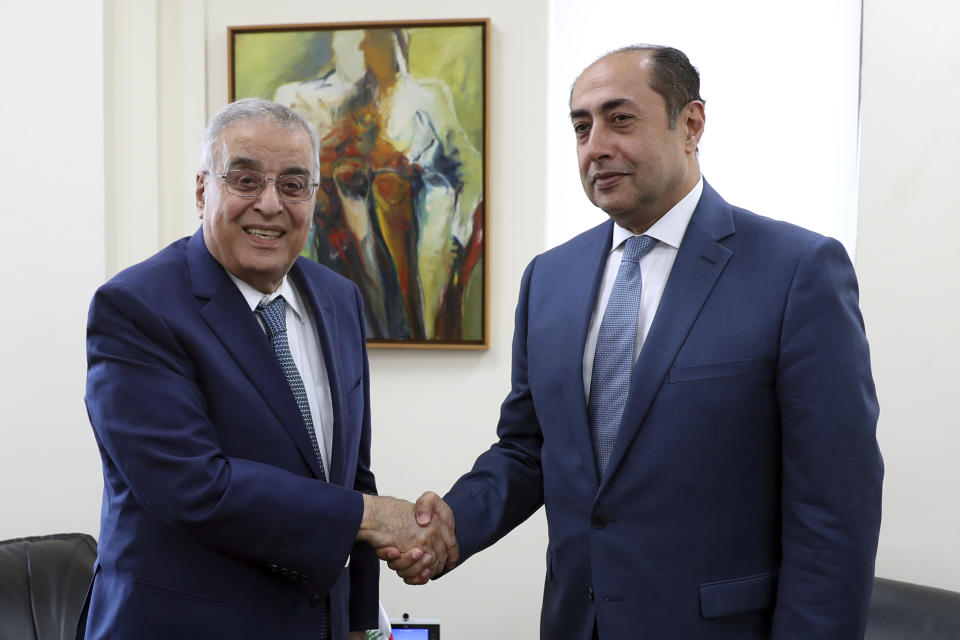 Lebanese Foreign Minister Abdallah Bouhabib, left, shakes hands with Assistant Secretary General responsible of the League's Council Hossam Zaki, in Beirut, Lebanon, Monday, Nov. 8, 2021. Zaki is in Beirut to explore ways to resolve an unprecedented diplomatic rift between Lebanon and Saudi Arabia that emerged following comments by Lebanon's information minister on Yemen's civil war. (AP Photo/Bilal Hussein)