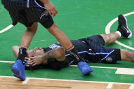 Orlando Magic guard Cole Anthony lies on the floor as teammate Khem Birch comes over to check on him during the second half of an NBA basketball game against the Boston Celtics, Friday, Jan. 15, 2021, in Boston. (AP Photo/Elise Amendola)