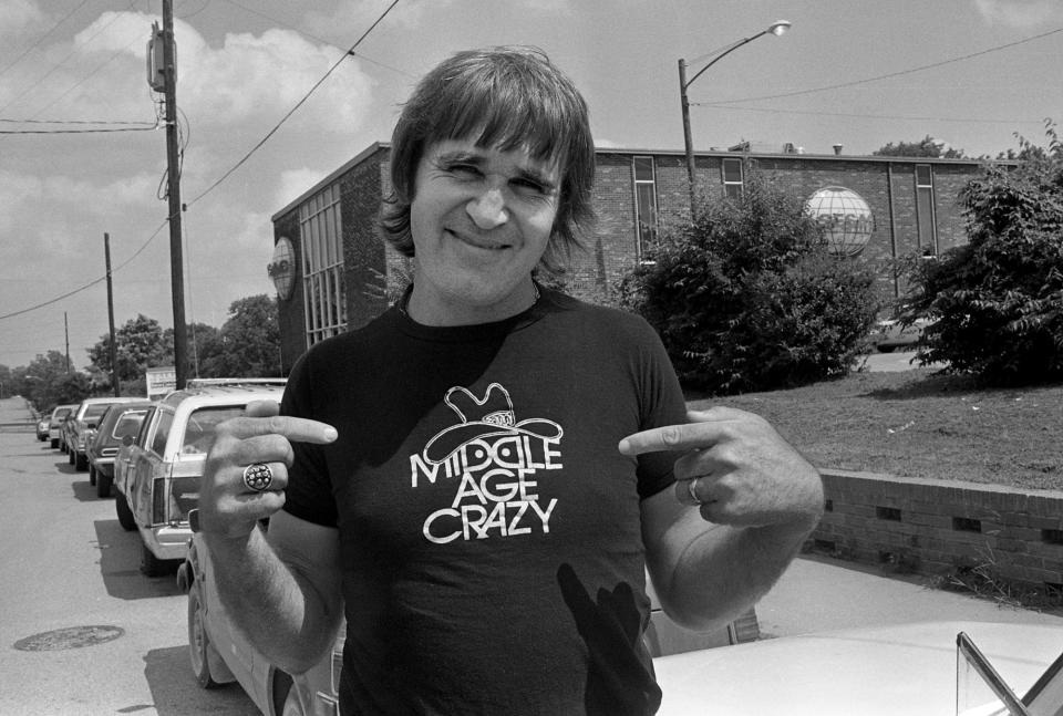 Sonny Throckmorton, a songwriter for Tree Publishing Co. and a Mercury Records recording artist, shows off his "Middle Age Crazy" T-shirt outside of Phonogram Inc. on Music Row on July 31, 1979. Hollywood producer Marty Kroft heard Throckmorton's 1977 hit "Middle Age Crazy" and decided to make a movie from it starring Bruce Dern and Ann-Margret. Kroft has since asked Throckmorton to write several more songs for the movie, including the closing song.