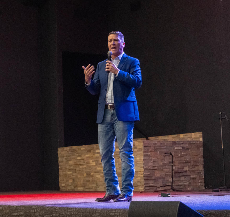 Rep. Ronny Jackson addresses the crowd at a town hall Tuesday at the Arena of Church in Amarillo.