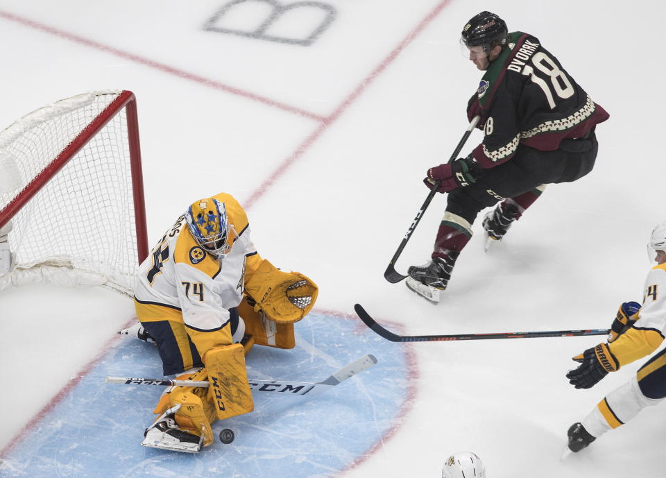 Nashville Predators goalie Juuse Saros (74) makes the save on Arizona Coyotes' Christian Dvorak (18) during second period NHL qualifying round game action in Edmonton, on Wednesday, Aug. 5, 2020. (Jason Franson/The Canadian Press via AP)