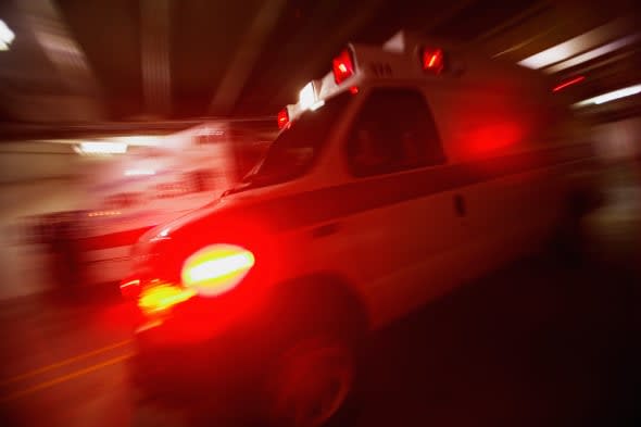 Ambulance pulling away from hospital (blurred motion)