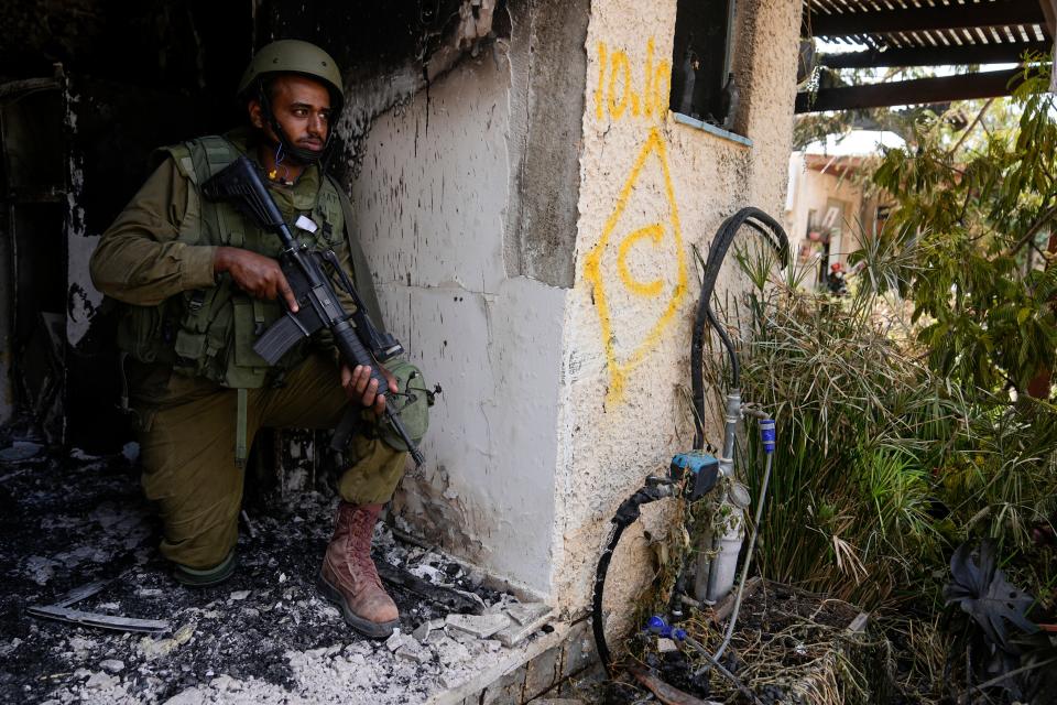 An Israeli soldier takes a position in Kibbutz Kfar Azza on Tuesday, Oct. 10, 2023. Hamas militants overran Kfar Azza on Saturday, where many Israelis were killed and taken captive.