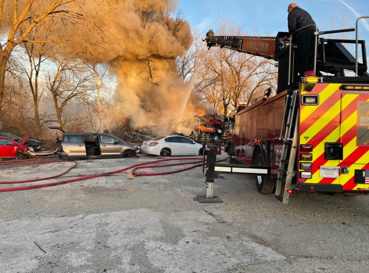 Wayne Township and surrounding departments battle a large fire at Happy’s Auto Salvage, 500 S. Tibbs Ave., on Monday, Dec. 13, 2021.