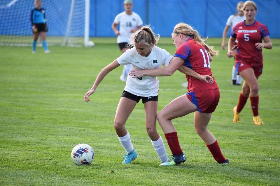 Monrovia's Nellie Standeford (10) battles for possession with Martinsville's Kenzie Cohen (11) during the Bulldogs matchup with the Artesians on Sept. 28, 2022.