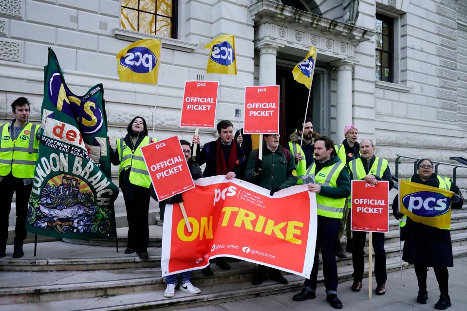 PCS members at a picket line out the office of HM Treasury, in Westminster (PA)