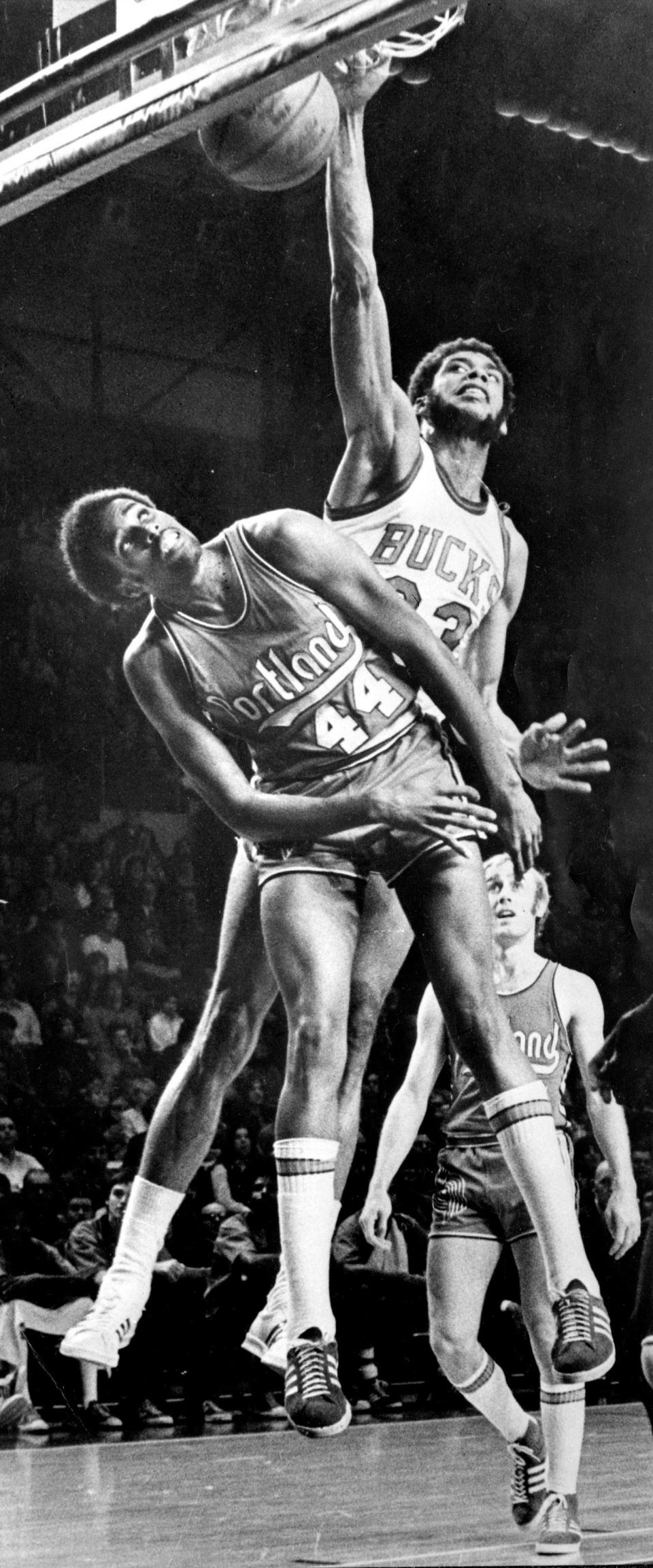 Kareem Abdul-Jabbar dunks the ball over Portland's Ollie Johnson in November of 1973.