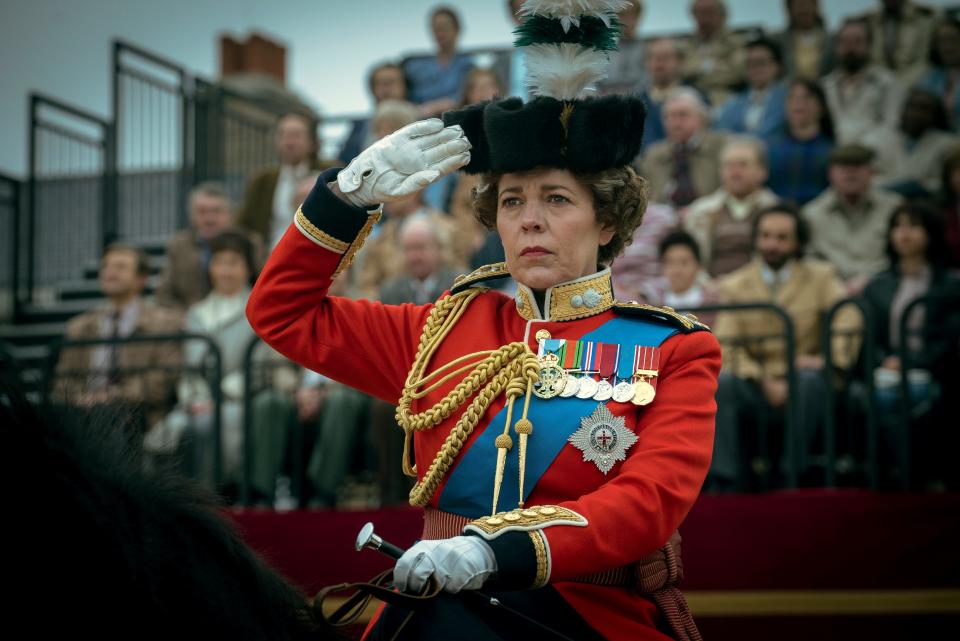 Olivia Colman raises a salute as Queen Elizabeth II in "The Crown."