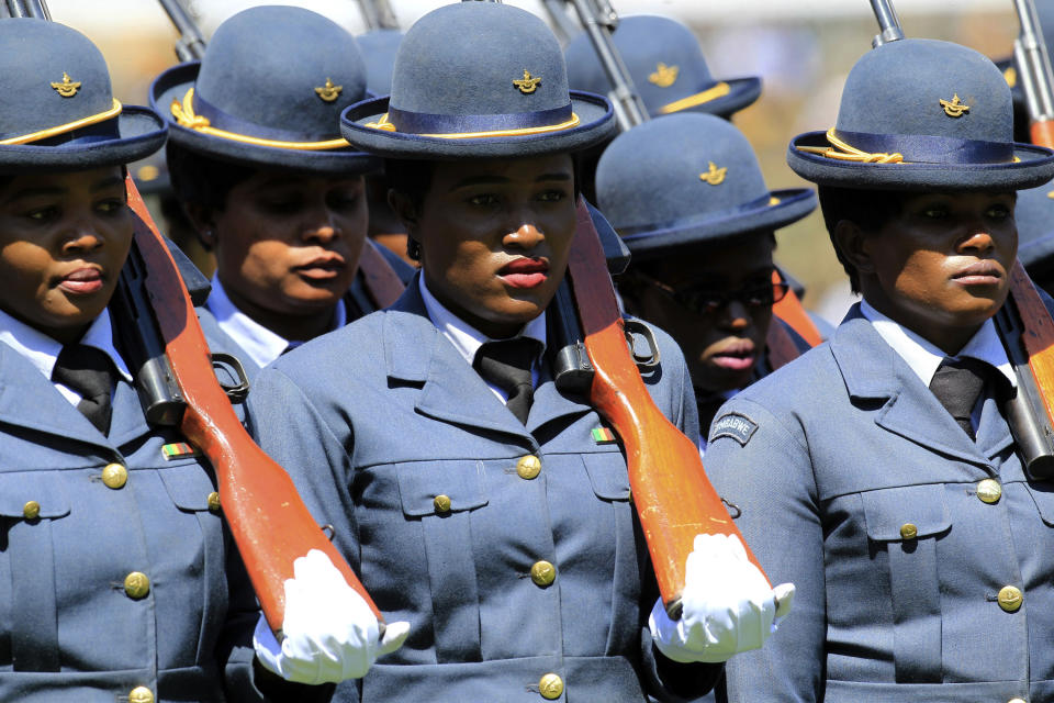 Members of the Defence Forces take part in Zimbabwean President Emmerson Mnangagwa's inauguration ceremony at the National Sports Stadium in Harare, Sunday, Aug. 26, 2018. Zimbabwe on Sunday inaugurated a president for the second time in nine months as a country recently jubilant over the fall of longtime leader Robert Mugabe is now largely subdued by renewed harassment of the opposition and a bitterly disputed election. (AP Photo/Tsvangirayi Mukwazhi)
