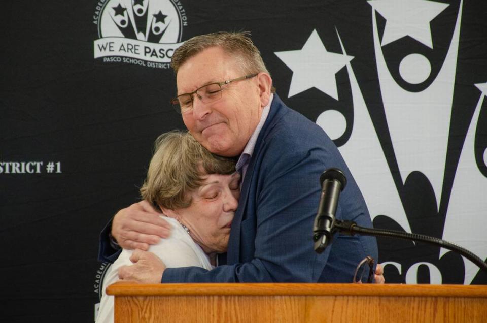 State Rep. Mark Klicker, R-Walla Walla, hugs Nancy Lenhart of Pasco during an event May 16 celebrating the new Richard L. Lenhart Act. Her husband was the Pasco School District bus driver who was stabbed to death in 2021.