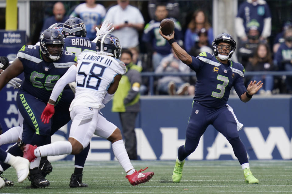 Seattle Seahawks quarterback Russell Wilson (3) passes to wide receiver Freddie Swain (not shown) for a touchdown against the Tennessee Titans during the second half of an NFL football game, Sunday, Sept. 19, 2021, in Seattle. (AP Photo/Elaine Thompson)