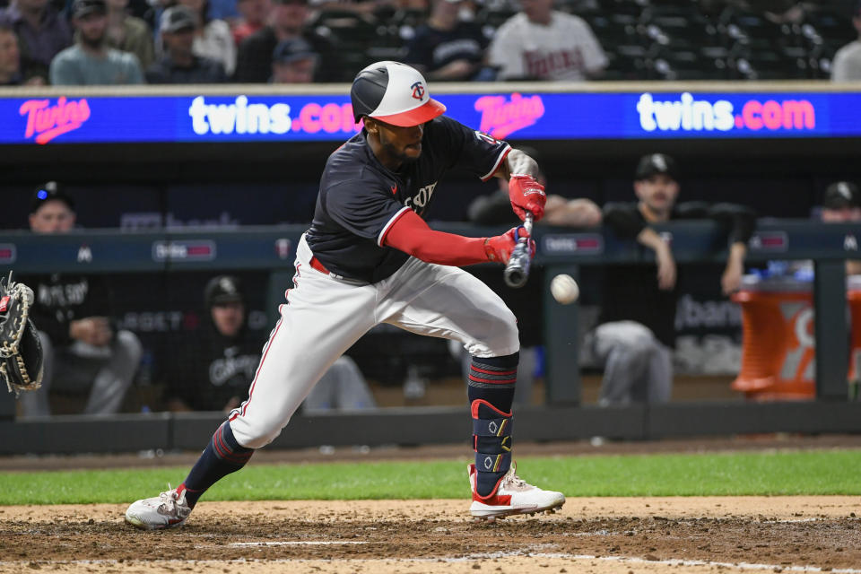 Minnesota Twins' Michael Taylor bunts against the the Chicago White Sox during the 10th inning of a baseball game Tuesday, April 11, 2023, in Minneapolis. The runner at second scored on a throwing error to first on the bunt. (AP Photo/Craig Lassig)