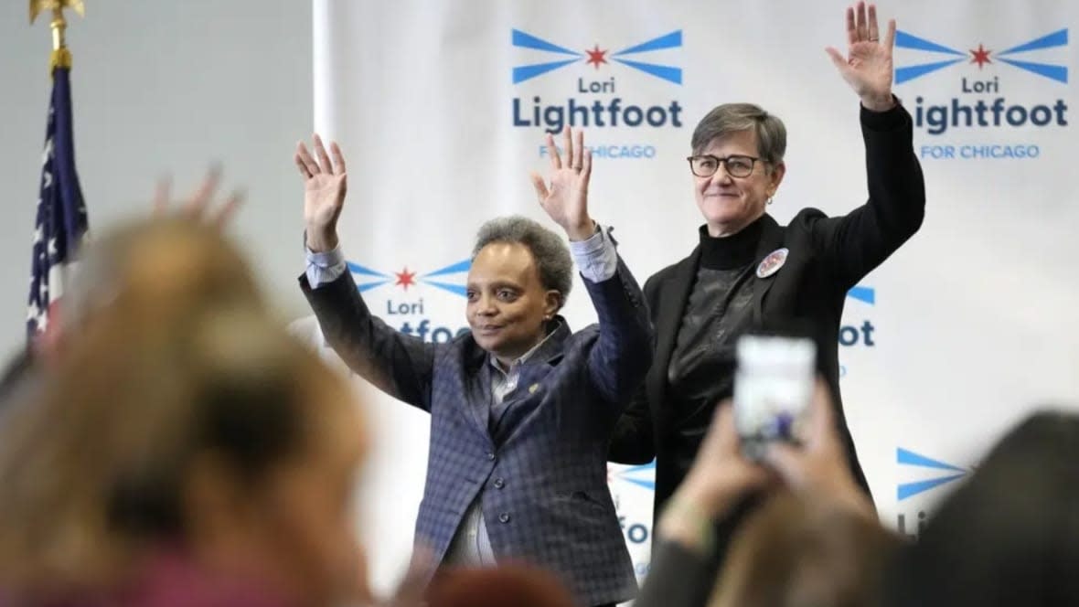 Chicago Mayor Lori Lightfoot (left) and her spouse, Amy Eshleman, wave to supporters during Women for Lori Rally in Chicago held Saturday. Lightfoot is fighting for reelection Tuesday after a history-making but tumultuous four years in office and a bruising campaign threaten to make her the city’s first one-term mayor in decades. (Photo: Nam Y. Huh/AP)