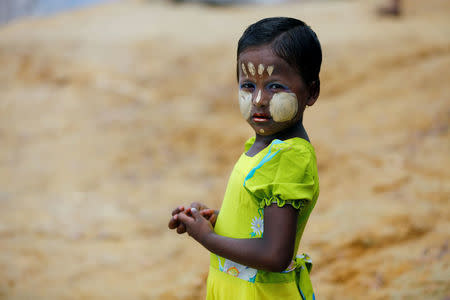 A Rohingya refugee girl wears a new dress and applies cosmetics to celebrate Eid al-Adha at the Kutupalang makeshift refugee camp, in Cox’s Bazar, Bangladesh, September 2, 2017. REUTERS/Mohammad Ponir Hossain