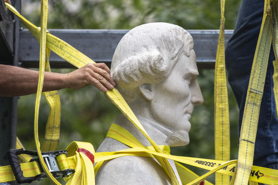 FILE - Workers secure a statue of Jefferson Davis to a trailer after removing it from the the Kentucky state Capitol in Frankfort, Ky., on Saturday, June 13, 2020. Kentucky lawmakers would claim authority over what statues are installed or removed from the state Capitol's Rotunda under a bill passed Friday, March 1, 2024, by the GOP-led House, a move the bill sponsor said has nothing to do with the removal of a statue of Confederate President Jefferson Davis. (Ryan C. Hermens/Lexington Herald-Leader via AP, File)