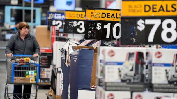 PHOTO: FILE - Signs advertise deals at a Walmart in Secaucus, N.J., Nov. 22, 2022. (Seth Wenig/AP, FILE)