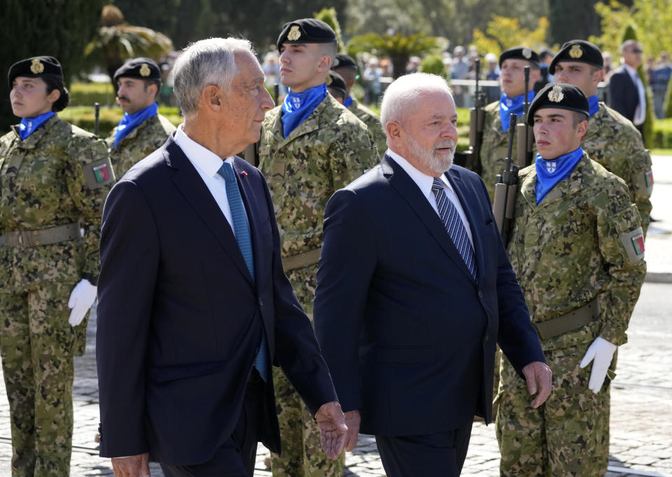 Brazilian President Luis Inacio Lula da Silva and Portuguese President Marcelo Rebelo de Sousa reviewing the troops during welcome ceremony outside the 16th century Jeronimos monastery in Lisbon, Saturday, April 22, 2023. Lula da Silva is in Lisbon for a four day state visit to Portugal. (AP Photo/Armando Franca)