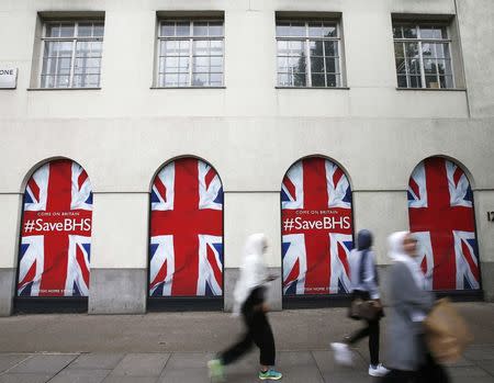 People walk past the headquarters of retailer British Home Stores after it was announced that BHS is to be wound down after administrators failed to find a buyer for the 88-year-old retailer, in central London, Britain June 2, 2016. REUTERS/Peter Nicholls