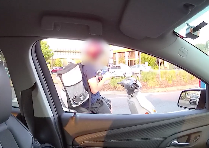 A food delivery driver was caught sitting in traffic on his phone. Source: QLD Police