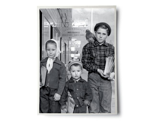 Black and white photo of Jerry, his siblings, and pigeon as children