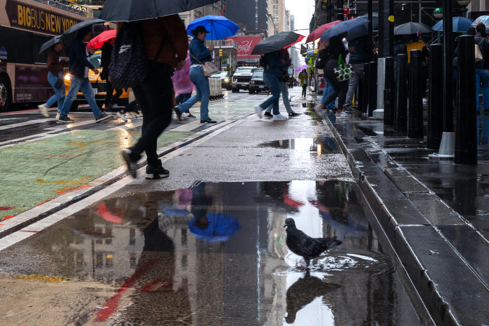 People crossing the street in the rain in New York