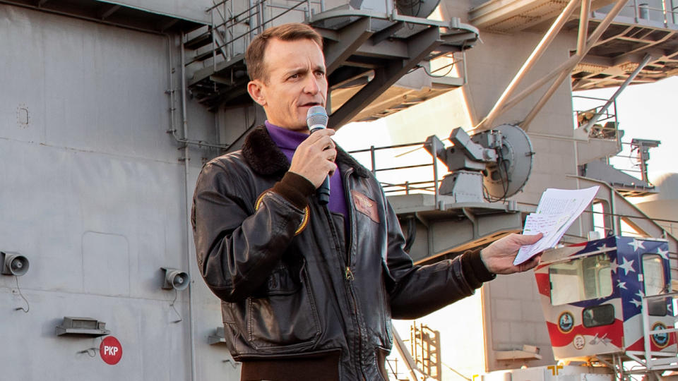 Capt. Brett Crozier, commanding officer of the aircraft carrier USS Theodore Roosevelt (CVN 71), gives remarks during an all-hands call on the ship's flight deck on Dec. 15, 2019. (Mass Communication Specialist Seaman Alexander Williams/U.S. Navy)