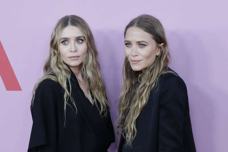 Ashley Olsen (L), pictured with Mary-Kate Olsen, recently welcomed her first child with her husband, Louis Eisner. File Photo by John Angelillo/UPI